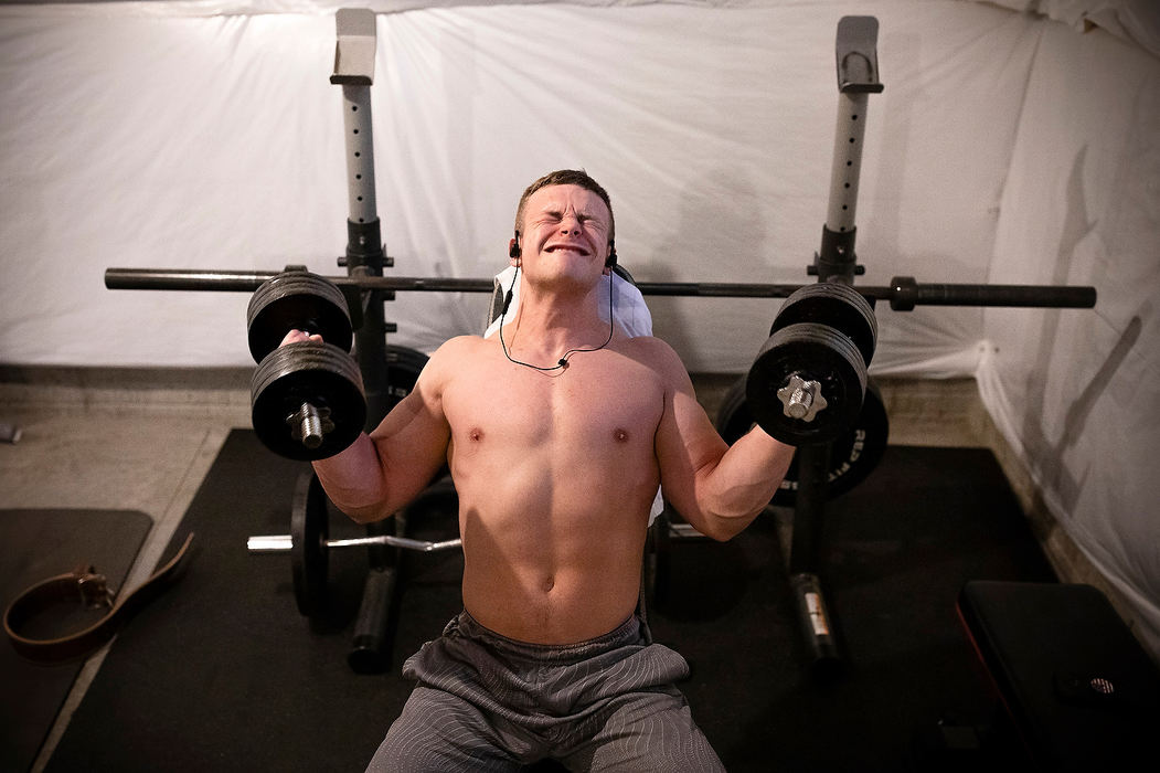 Story - 2nd placeGarrett Ford knocks out a round of dumbbell curls while training in his basement gym at his home in Pataskala. Ford, 20, is a person with autism and a Special Olympian who competes in powerlifting, a sport that tests an athlete's ability in three lifts: the deadlift, the bench press and the squat. Garrett trains several days a week, often in his basement but also at two gyms in Licking County.(Joshua A. Bickel / The Columbus Dispatch)